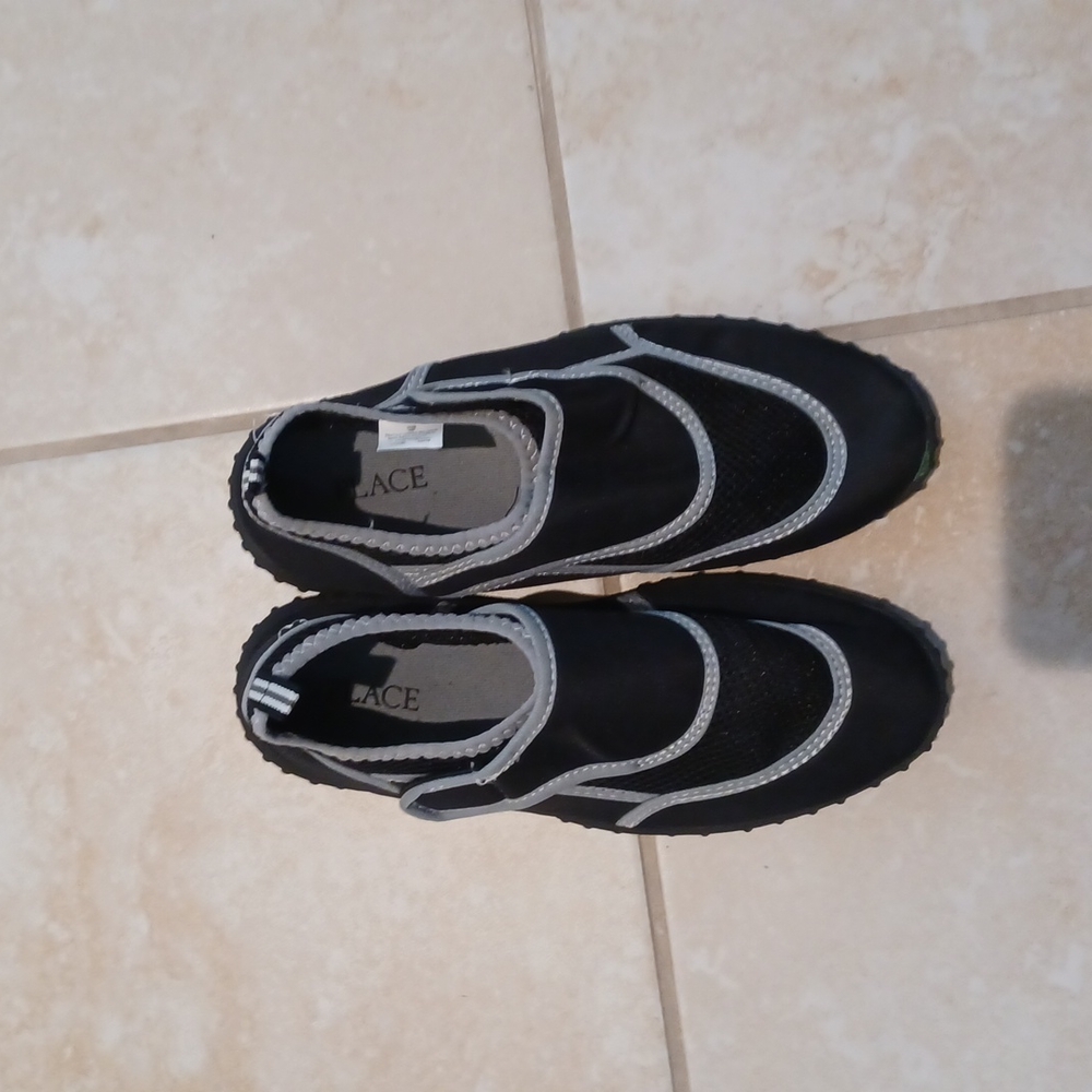 Black and grey place water shoes (havent been used)
